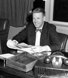 Photo of Robert F. Chandler smiling at his desk