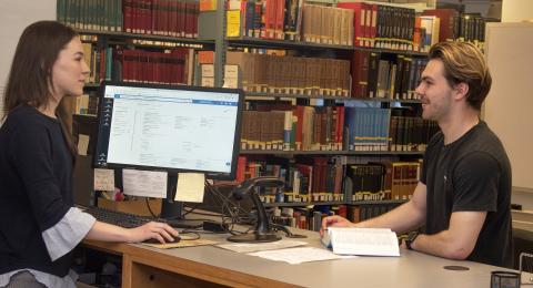 Student helping another student at the Chemistry library desk