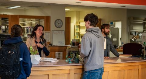 Students talking with employees at Dimond Information Desk