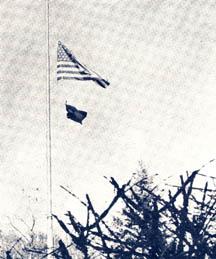 US flag and black flag on flag pole