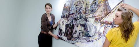 Masters of Fine Arts students hanging paintings in Museum
