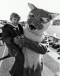 1983 wildcat mascot with child on the field