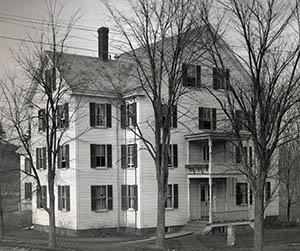 Ballard Hall with bare trees in foreground.