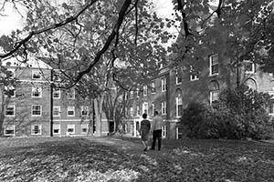 South side of Congreve Hall in autumn with two people walking on walkway.