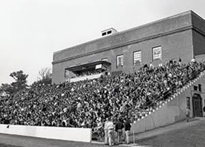Rear of Field House with bleachers full of people.