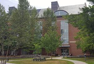 Main entrance to Gregg Hall with picnic area in the foreground, July 2016.