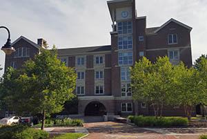 Facade of Haaland Hall with view of front entrance and clocktower, July 2016.