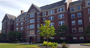 Mills Hall with trees in foreground, taken from back of College Row, July 2016.