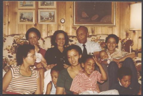 Ivorey Cobb and family, sitting together on a floral 1970s couch