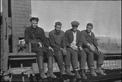 Four men on rail car, ca. 1932-1933 in Michurinsk, Russia