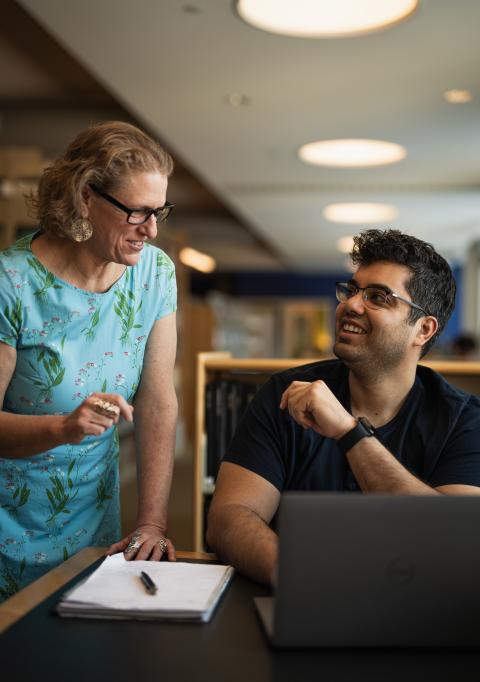 Librarian talking to a grad student