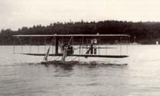 Biplaine flying across lake